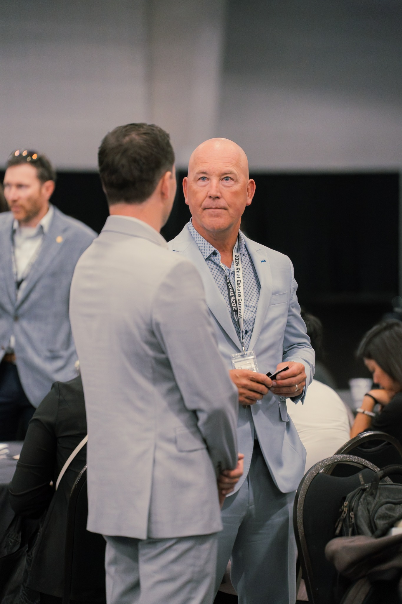 Business professionals talking together during a conference.